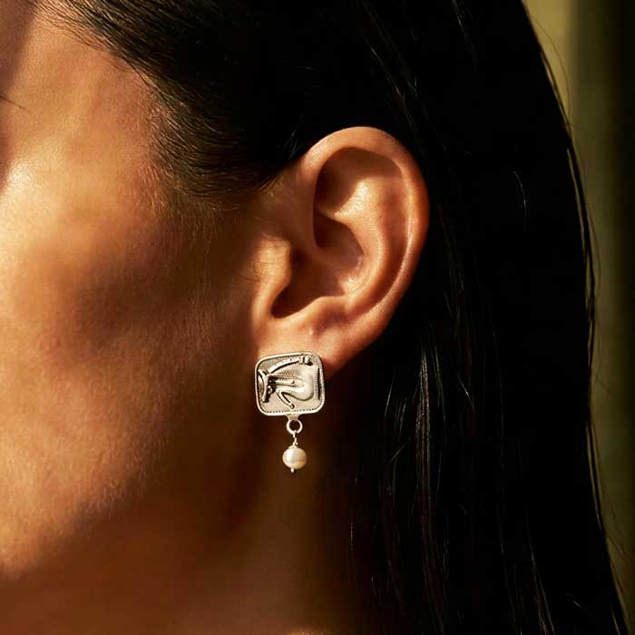 sterling silver earrings with jumper accented with pearl dangles shown on ear