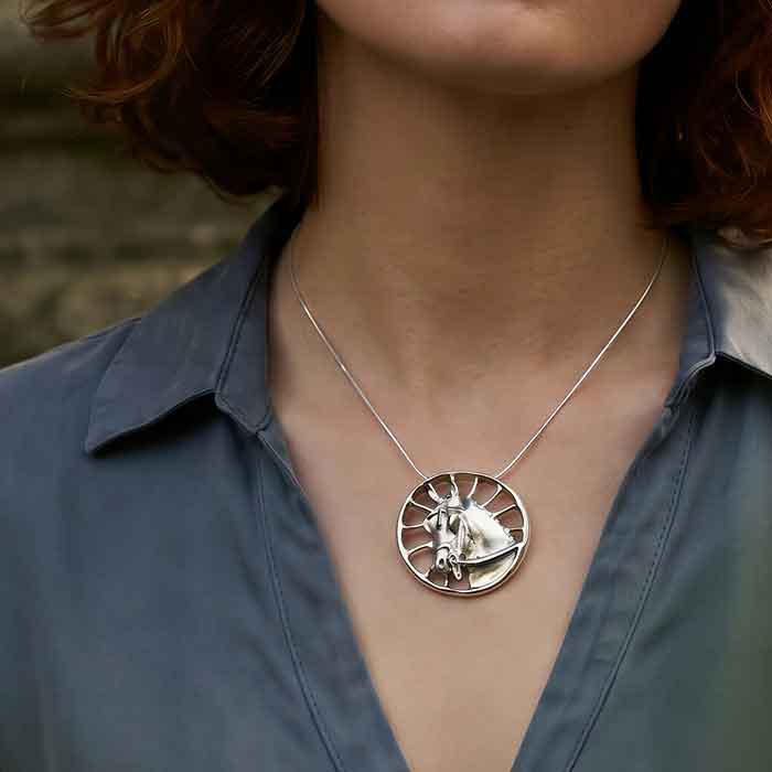 Carriage Horse Pendant Necklace in Sterling Silver shown on a carriage driving person