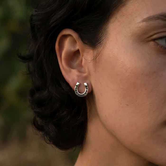 Horseshoe Stud Earrings in Sterling Silver shown on horse lover