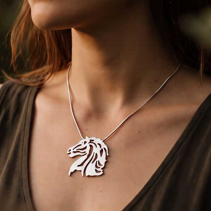 Raffles Horse Head Pendant Necklace in Sterling Silver shown on a horse lover's neckline