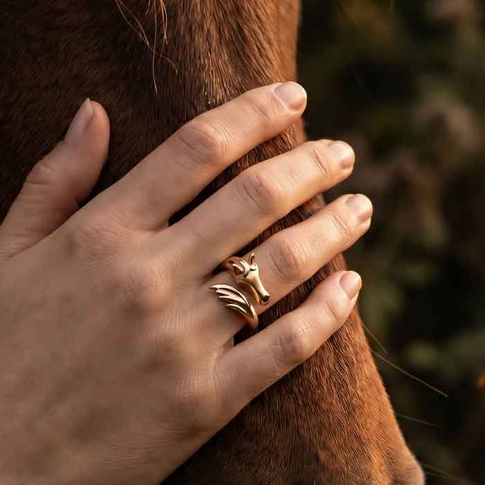 Horse Head and Tail Ring in Bronze shown on horse lovers hand on horse