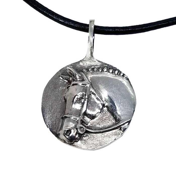 The image shows a sterling silver pendant necklace featuring a raised relief depiction of a classic Hunter Horse with a snaffle bit bridle and braided mane. The pendant is circular and has an omega-shaped bail at the top.
