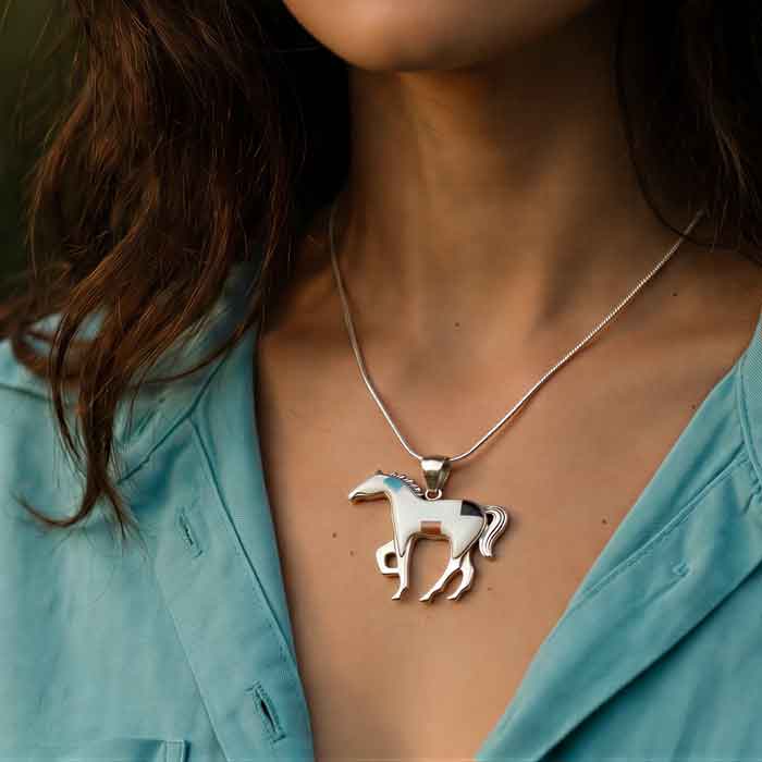 Blanche inlay horse pendant necklace shown on neck of horse lover