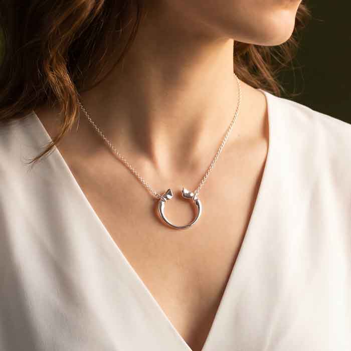 Caballo horse hoof horseshoe necklace shown on person