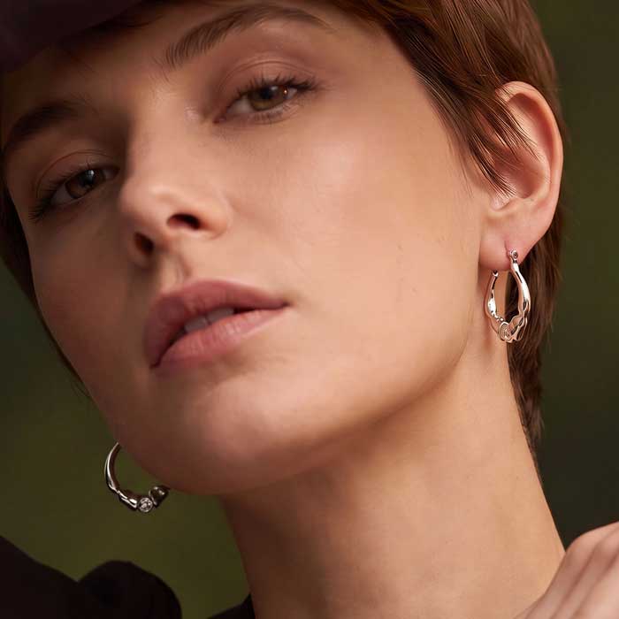 Caballo horse hoof horseshoe hoop earrings in sterling silver shown on a horse lover