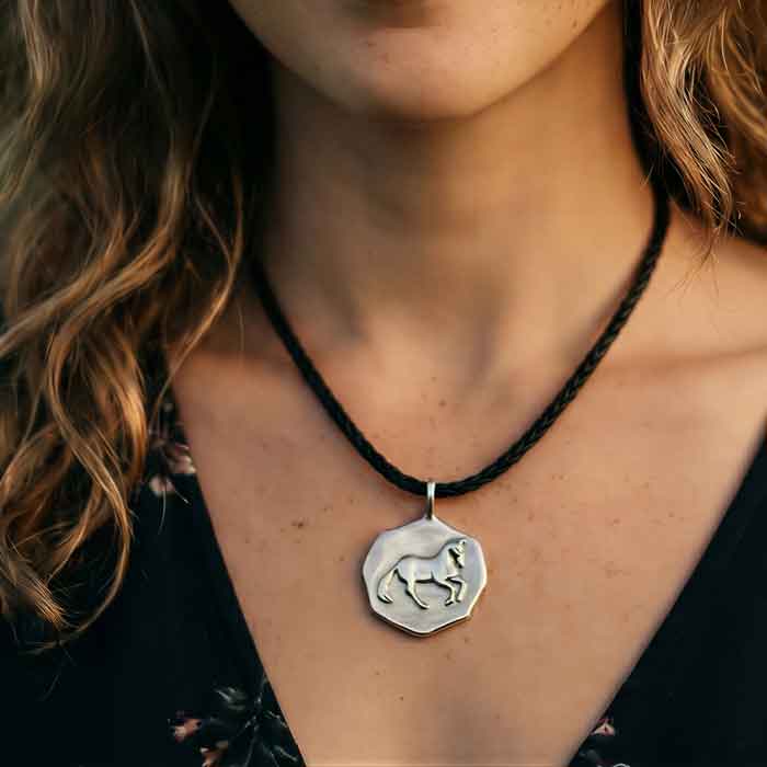 Canter Pirouette Dressage Horse Pendant Necklace Sterling Silver shown on horse lover's neck