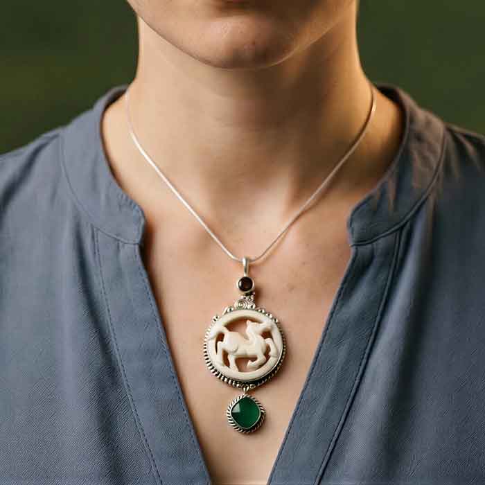 Darcy Carved Horse Pendant Necklace with garnet and green chrome diopside shown on person