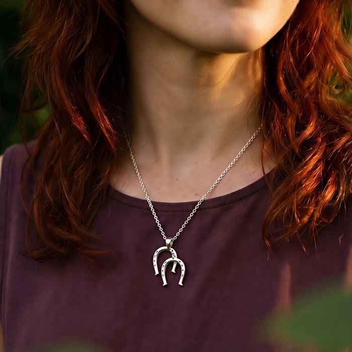Double horseshoe pendant necklace sterling silver shown on person