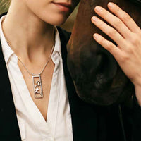 Framed Pair of Horses Necklace sterling silver shown on person 