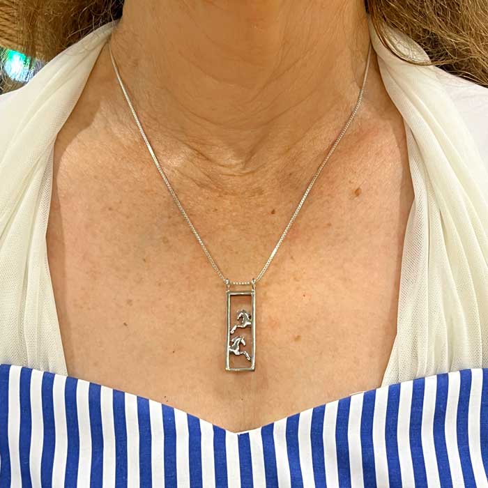 Framed pair of horses necklace sterling silver on woman