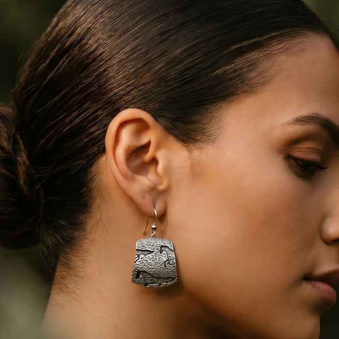 Ghost Horse Dangle Earrings sterling silver shown on horse lover's ear