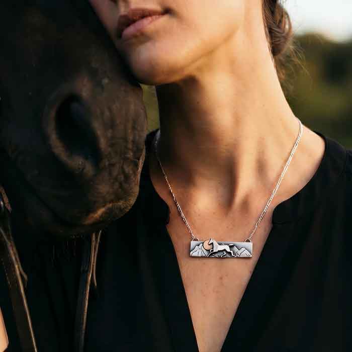 Horse, Mountains, Sun Bar Necklace Sterling Silver and 14k Gold shown on horse lover's neck