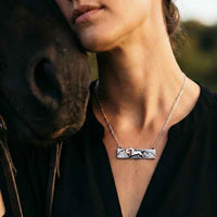 Horse, Mountains, Sun Bar Necklace Sterling Silver and 14k Gold shown on horse lover's neck