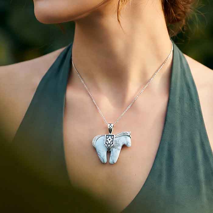 White Howlite Horse Necklace Pendant with decorative Sterling Silver mane and tail and saddle shown on person