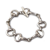 A sterling silver bracelet featuring a chunky chain design of horse bit snaffle bit, closing with a toggle.
