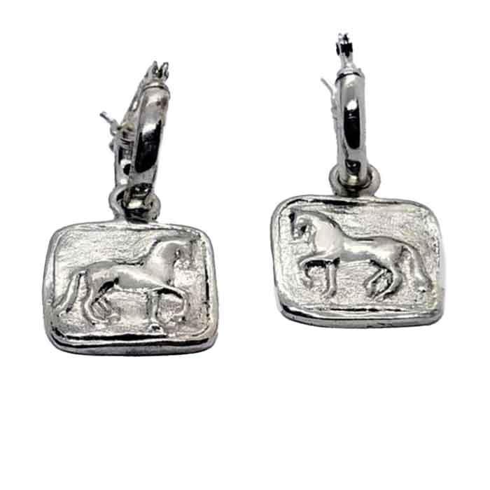 A pair of sterling silver hoop-style dressage horse earrings, with the hoops in a silver finish and the horses engraved on a square or round charm.