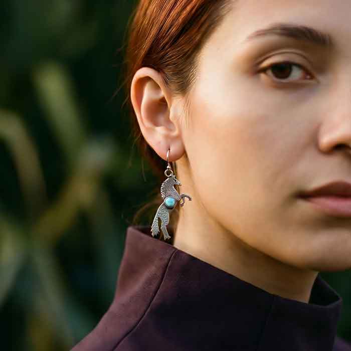 rearing stallion dangle earrings with Opal sterling silver shown on woman