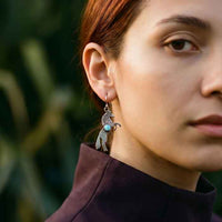 rearing stallion dangle earrings with Opal sterling silver shown on woman
