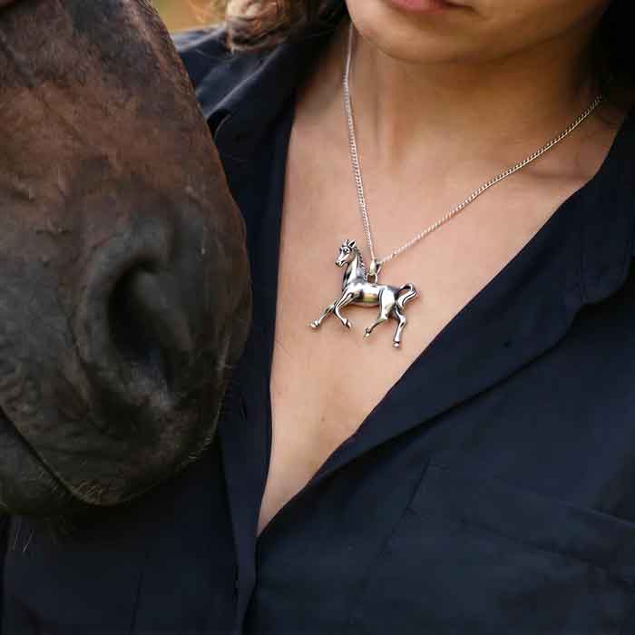 Serfina horse pendant necklace sterling silver on person next to horse
