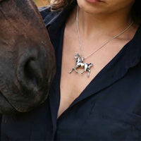 Serfina horse pendant necklace sterling silver on person next to horse