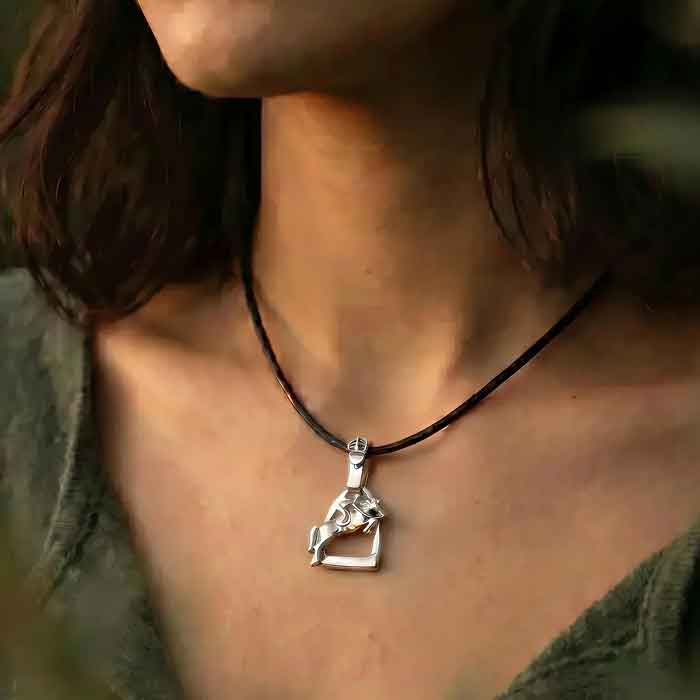 Stirrup with jumping horse and rider in sterling pendant necklace shows on person