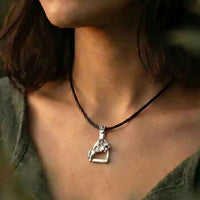 Stirrup with jumping horse and rider in sterling pendant necklace shows on person