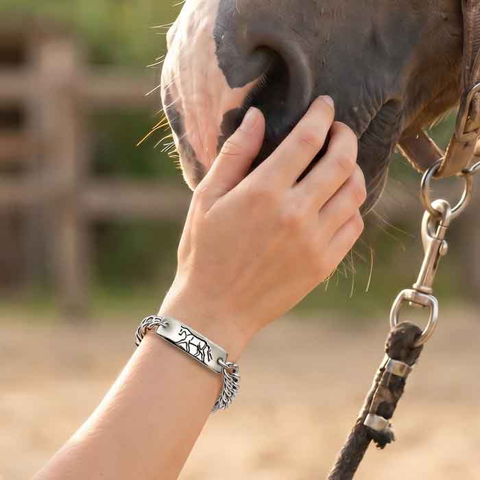 Trotting ID bracelet with curb chain in sterling silver on person's wrist