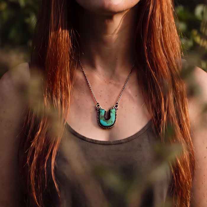Turquoise Horseshoe Pendant Necklace set in Sterling Silver shown on neck of horse lover