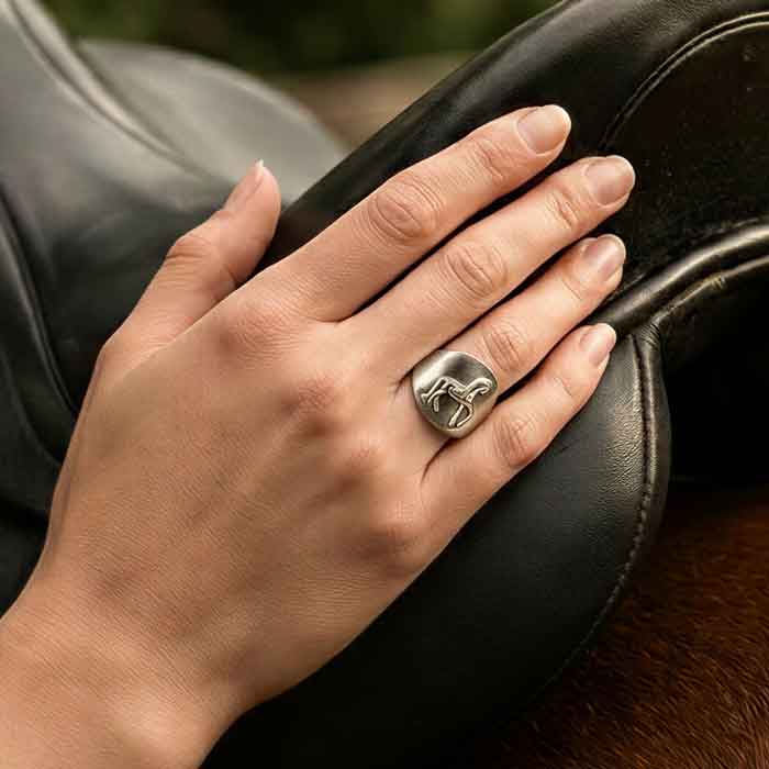 Sterling Silver Dressage Horse Piaffe Ring  shown on womans hand by dressage saddle