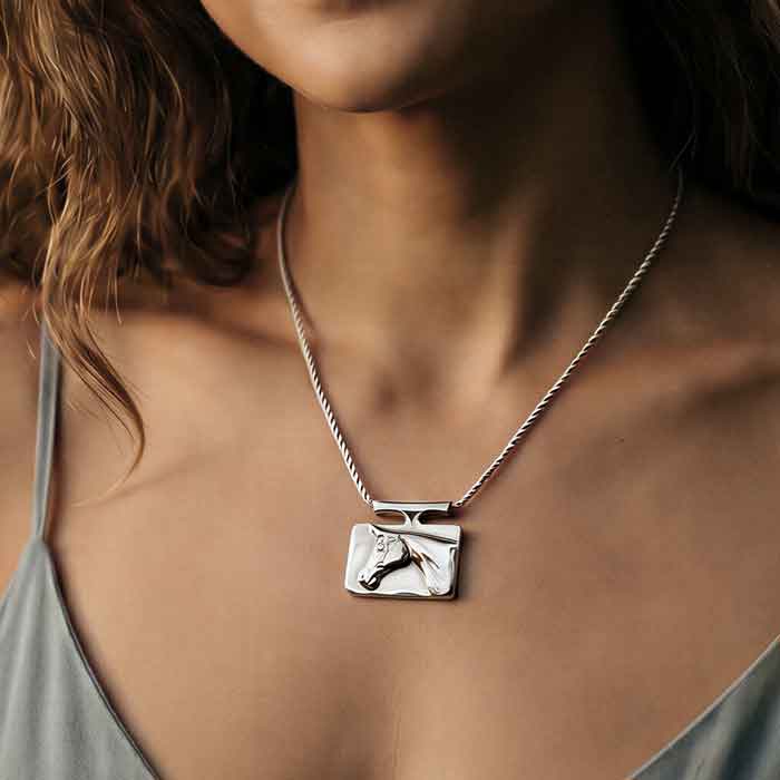 Classy Horse Head Necklace sterling silver shown on a horse lover