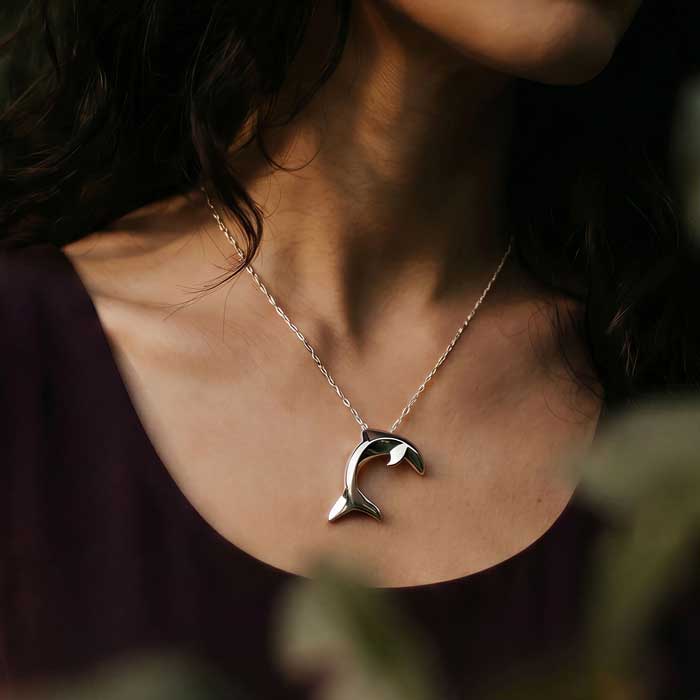 Dolphin Pendant Necklace  in sterling silver shown on woman