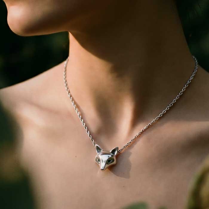 Fox Mask Pendant Necklace -sterling silver with green sapphire eyes shown on womans neck