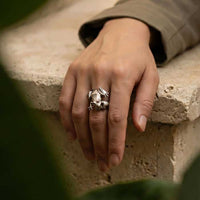 Frog Ring in Sterling Silver with ruby red eyes shown on womans hand