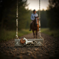 necklace with horse in mountain landscape with trail rider blurry 