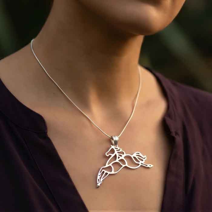jupiter jumping horse pendant necklace in sterling silver shown on person