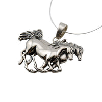 Span of Horses Necklace in Sterling Silver. Two horses side by side, stride for stride from an angle