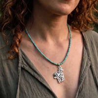 Storyteller horse pendant in sterling silver on turquoise necklace shown on horse lover