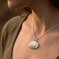 Horses Racing Across Landscape Pendant Necklace Sterling Silver shown on horse lovers neck