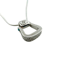 Western Stirrup Pendant Necklace Sterling Silver with turquoise accent  highlighting the decorative "tooling" around the stirrup
